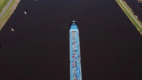 Aerial top down view following large tanker boat entering a canal Video stock 181234970