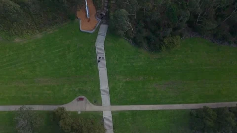 Aerial top-down view following a winding concrete path in a public park Stock Footage 339376572