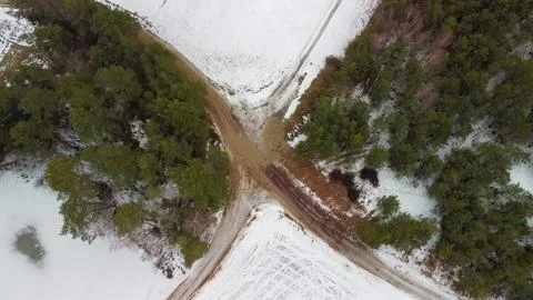 Aerial top-down view of a four-way crossroads in a rural area during winter Stock Photos