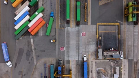 Aerial Top Down View of Freight Terminal with Trucks and Cargo Trains, October 7 Stock Footage 319006716