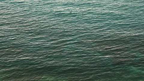 Aerial Top-Down View of Gentle Turquoise Sea Waves and Ripples Video stock 332154756