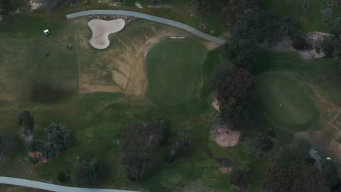 Aerial top down view of golfers playing on a luxury golf course Video stock 342576976