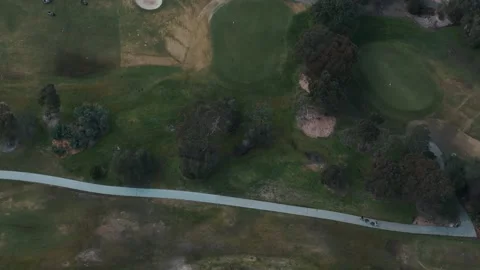 Aerial top-down view of golfers on a green golf course Video stock 342577133