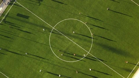 Aerial top down view of a green soccer field with people playing Stock Footage