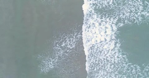 Aerial top down view of grey ocean waves on sand The Concept of Melancholy Stock-Footage 327752687