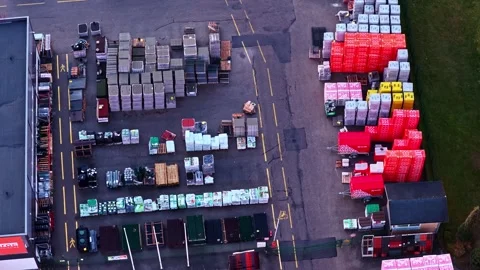 Aerial top down view of hardware store outdoor storage with forklifts moving Stock Footage 335893580