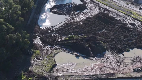 Aerial top-down view of heavy machinery moving earth at a construction site Stock Footage 341271506