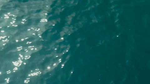 Aerial top down view from high altitude of green sea water texture. The camera Stock Footage 128408261