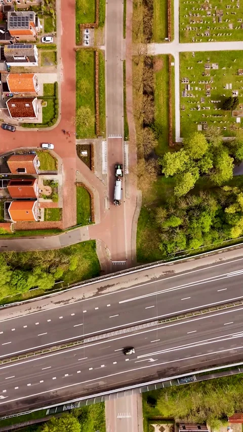Aerial top-down view of highway traffic and small town Stock Footage 327114203