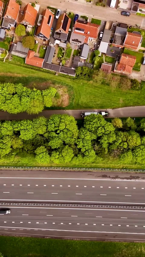Aerial top-down view of highway traffic and dutch town Video stock 327114296