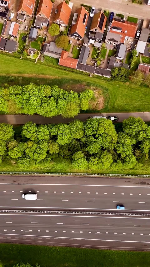 Aerial top-down view of highway traffic and dutch village Stock-Footage 327114388