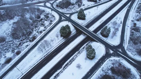 Aerial top down view of highway intersection and roundabout covered in whit.. Stock-Footage 327582605