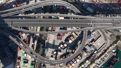 Aerial top down view of highway interchange and industrial port 스톡 동영상 329595773