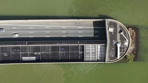 Aerial top down view of highway entering tunnel over water 库存影片 334119153
