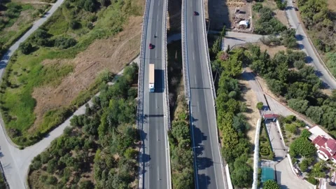 Aerial top-down view of highway lanes tilting up to mountain tunnel Stock Footage 343962472