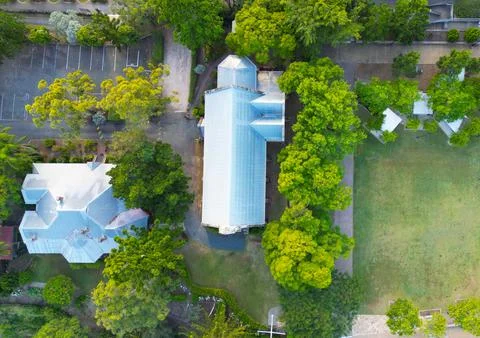 Aerial top-down view of a historic church roof and grounds Stock Photos