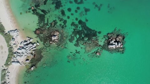 Aerial top down view of huge rocks in the sea, turquoise water and the beach Stock-Footage 167721370