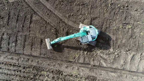 Aerial top-down view of hydraulic excavator on brown soil 4k Stock Footage 74891836