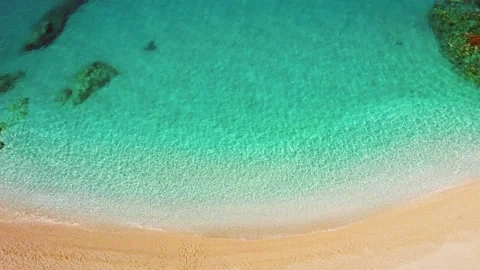 Aerial top down view of idealistic beach with clear turquoise water and yellow Stock-Footage 214662178