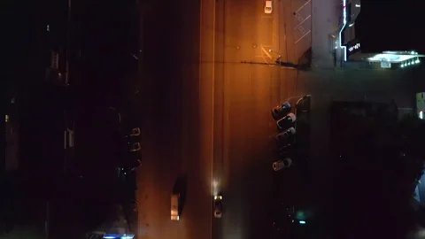 Aerial top down view of illuminated city road at night with car traffic, drone Stock Footage 107774554