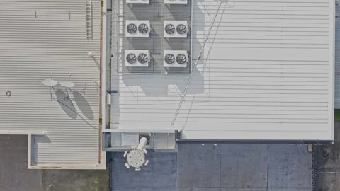 Aerial top down view of industrial building roof with air conditioning units Stock Footage 340594649