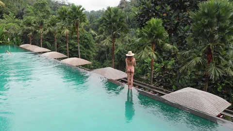 Aerial Top Down View of Infinity pool at luxurious exotic island. Back view of Stock Footage 128241746