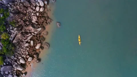 Aerial top down view of kayaker on coastline Stock Footage