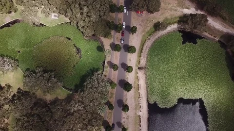 Aerial top down view of a lakeside road - 4K Stock Footage 85323251