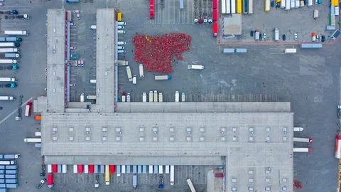 Aerial top down view of the large logistics park with warehouse and semi trucks Stock Footage