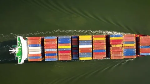 Aerial top down view of large container cargo ship traveling with slow speed. Stock Footage 243556531