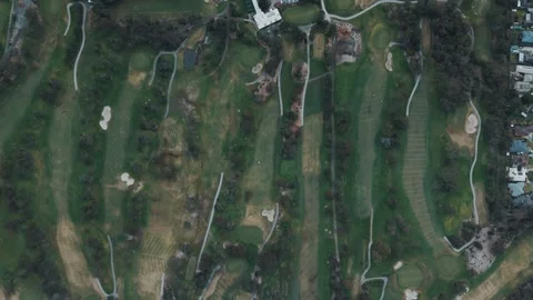 Aerial top-down view of a large green golf course Видео 342574150