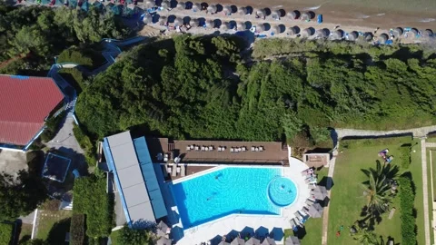 Aerial top down view of large luxury pool and scenic beach in Greece Stock Footage 343940567
