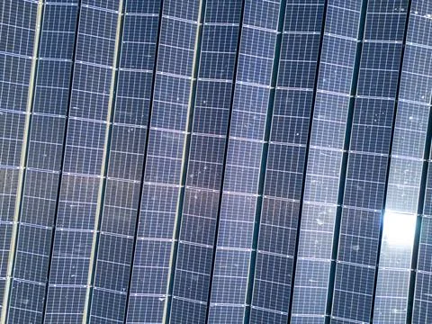 Aerial top down view of a large array of solar panels on a roof Stock Photos