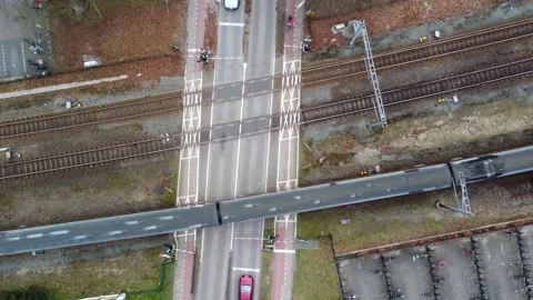 Aerial top down view of level crossing high speed train passing over 4k Stock Footage 152612904