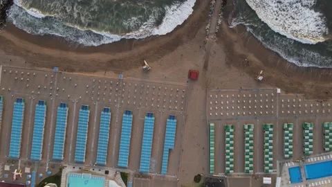 Aerial top down view of long beach resort and waves in coast Stock Footage 152270830