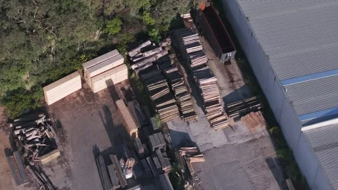 Aerial top-down view of a lumber yard with stacks of wood and logs 動画素材 346363019