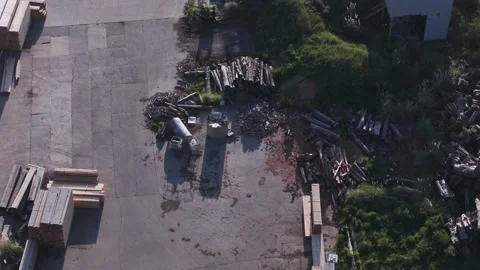 Aerial top-down view of lumberyard and concrete industrial area Stock Footage 346364173