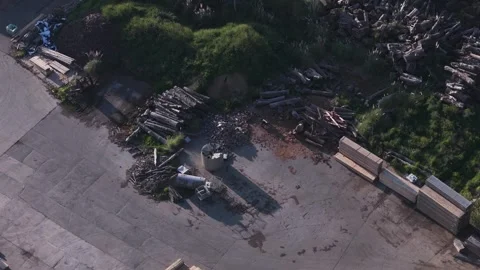 Aerial top down view of a lumberyard with stacked wood and logs 動画素材 346365314