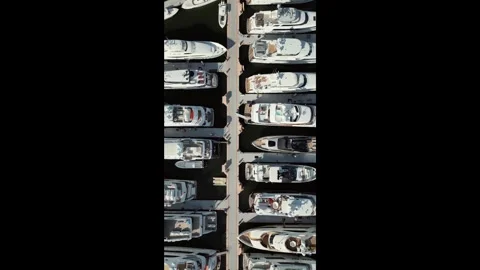 Aerial top-down view of luxury yachts and motorboats at modern marina Video stock 327672177