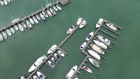 Aerial top down view of luxury yachts and sailboats moored at a marina Stock-Footage 337811518