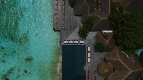 Aerial top down view of Maldives resort infinity pool and lagoon Stock Footage 337704377
