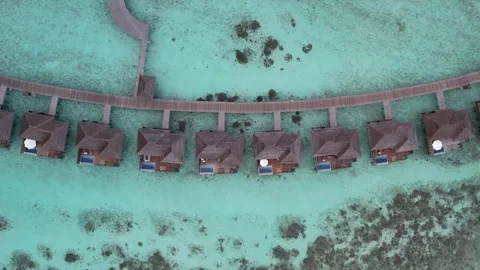 Aerial Top Down View of Maldives Overwater Villas and Turquoise Reef Stock Footage 344129273