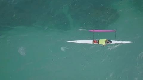 Aerial: top down view of a man canoeing in the ocean Stock-Footage 188354171