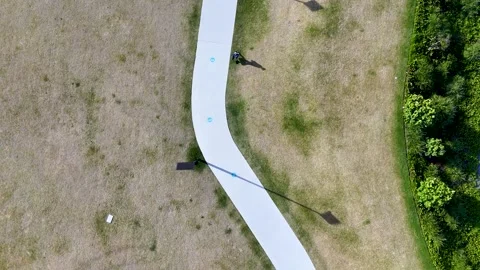 Aerial Top Down View of Man Walking on Park Path Stock Footage 341542675
