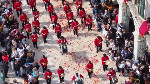 Aerial top down view of the marching band in red uniforms parading on a street Stock Footage 333783793