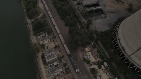 Aerial Top-Down View of a Massive Cooling Tower, Railway Tracks, and Highway Vidéo 332580152