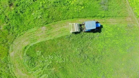Aerial top down view of modern tractor cutting grass in farmland Stock-Footage 93499863