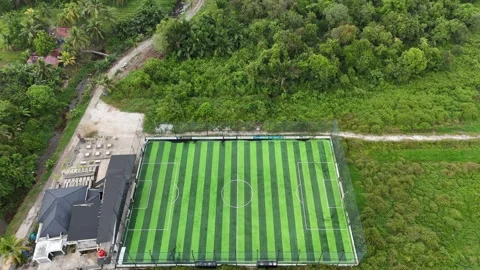 Aerial Top-Down View of Modern Mini Soccer Field Surrounded by Tropical Greenery Stock Footage 329838498