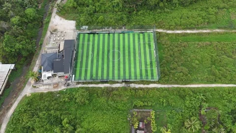 Aerial Top-Down View of Modern Mini Soccer Field Surrounded by Tropical Greenery Stock Footage 329838700
