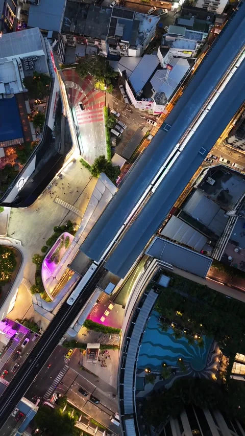 Aerial Top Down View of Monorail Train Arriving at a Modern Station in Bangkok, Stock Footage 335584696